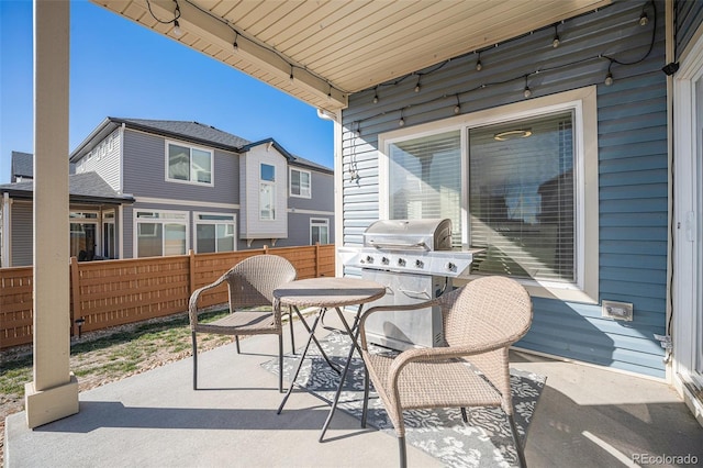 view of patio / terrace featuring grilling area, outdoor dining area, and fence