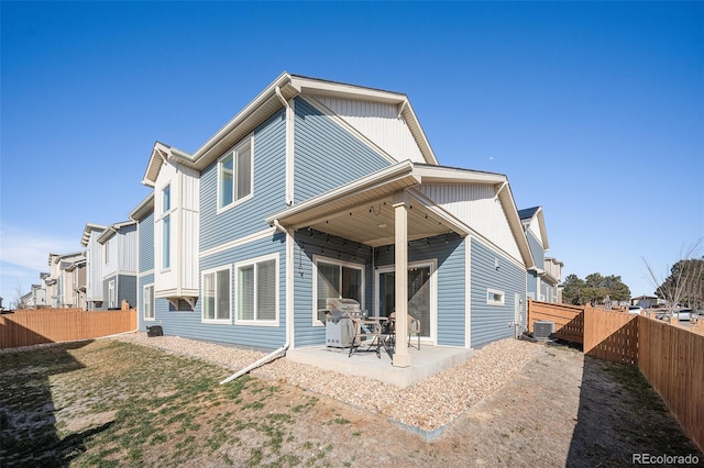 rear view of property featuring central air condition unit, a patio, and a fenced backyard