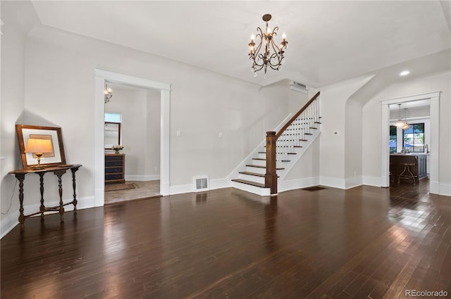 1024 Greenwood Ave, Canon City, CO 81212 - unfurnished living room featuring a chandelier, stairway, and wood finished floors