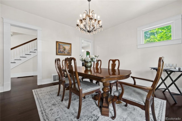1024 Greenwood Ave, Canon City, CO 81212 - dining room featuring a chandelier, stairway, and dark wood-style flooring