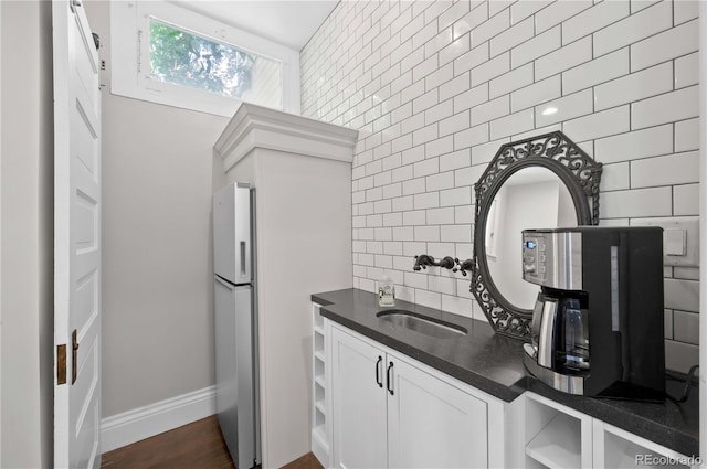 1024 Greenwood Ave, Canon City, CO 81212 - kitchen with dark countertops, open shelves, white cabinets, tasteful backsplash, and freestanding refrigerator
