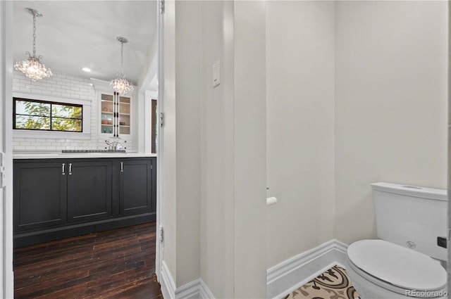 1024 Greenwood Ave, Canon City, CO 81212 - bathroom with vanity, hardwood / wood-style flooring, a chandelier, and decorative backsplash