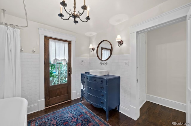1024 Greenwood Ave, Canon City, CO 81212 - foyer with tile walls, a chandelier, a wainscoted wall, and wood finished floors
