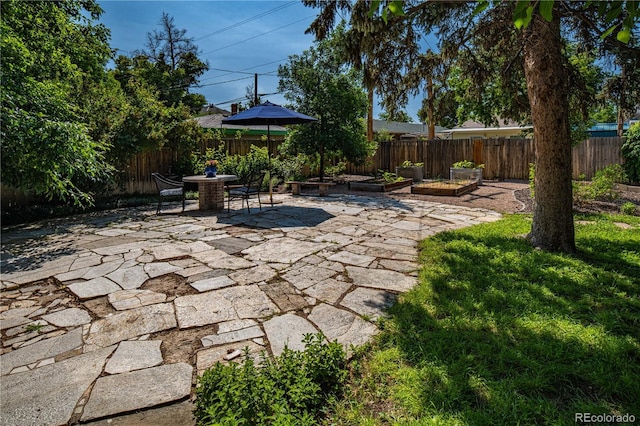 1024 Greenwood Ave, Canon City, CO 81212 - fenced backyard featuring a patio area, a vegetable garden, and outdoor dining space