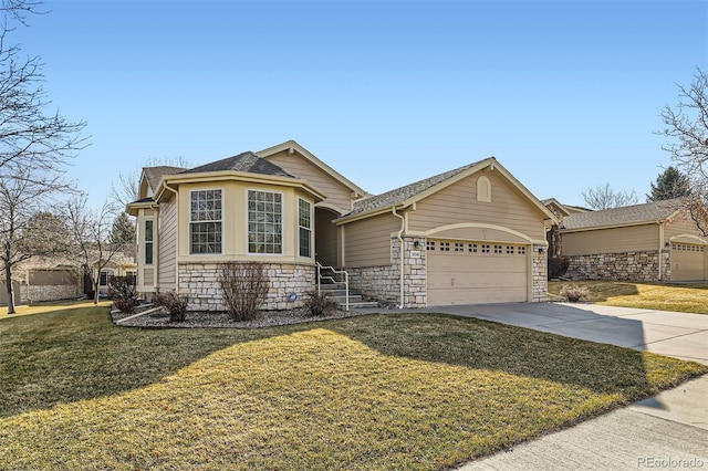 view of front facade with stone siding, a front yard, an attached garage, and driveway