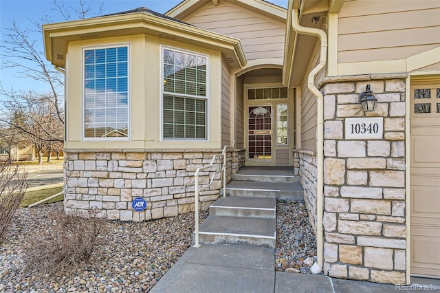 doorway to property featuring stone siding