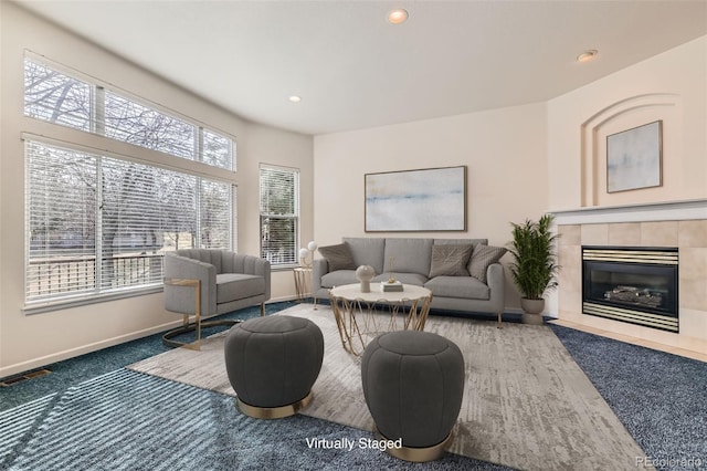 living room featuring recessed lighting, visible vents, baseboards, and a tile fireplace