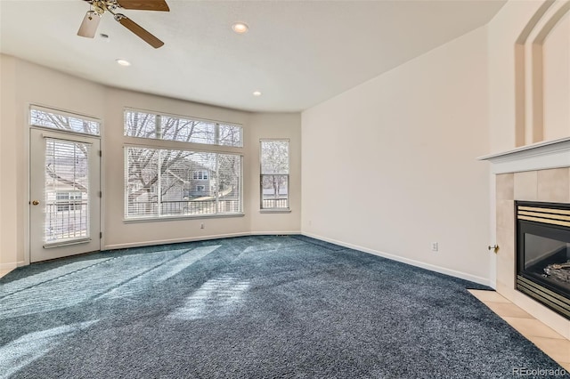 unfurnished living room featuring carpet, baseboards, a tiled fireplace, recessed lighting, and a ceiling fan