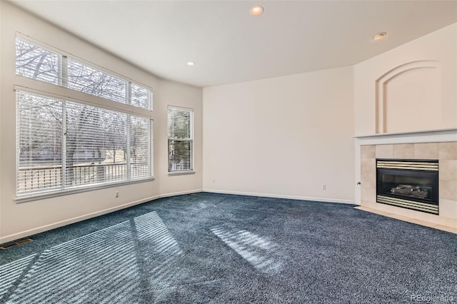 unfurnished living room with visible vents, recessed lighting, carpet floors, baseboards, and a tile fireplace