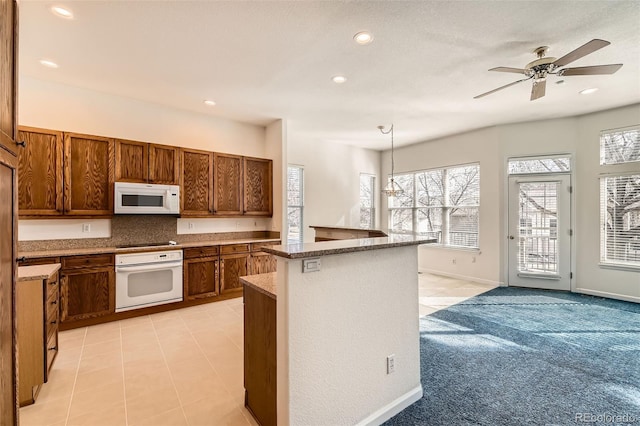 kitchen with backsplash, recessed lighting, brown cabinets, and white appliances