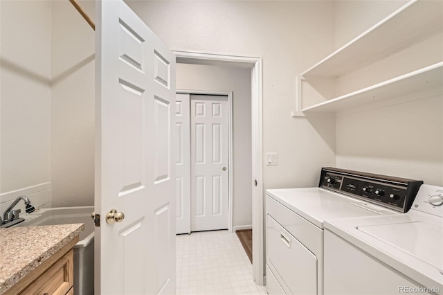 clothes washing area featuring independent washer and dryer and light floors