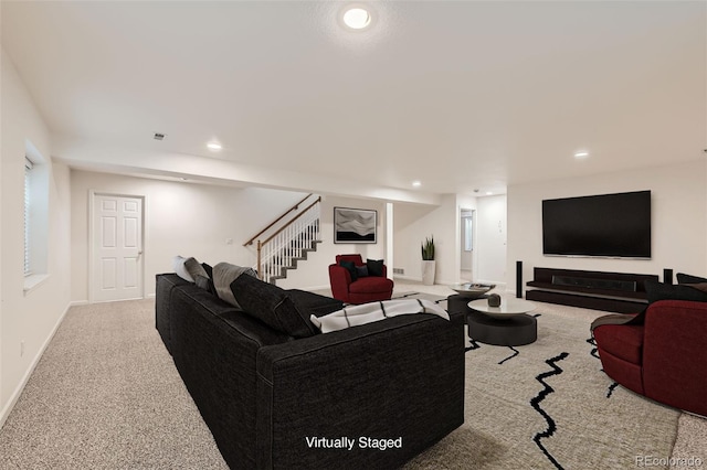 carpeted living room with recessed lighting, baseboards, and stairs