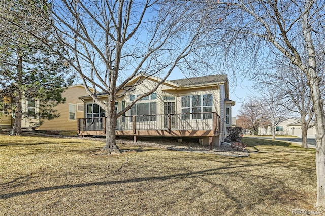 view of front of house with a deck and a front yard