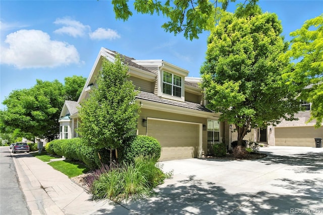 4545 S Monaco St Unit 114, Denver, CO 80237 - view of property hidden behind natural elements with driveway and a garage