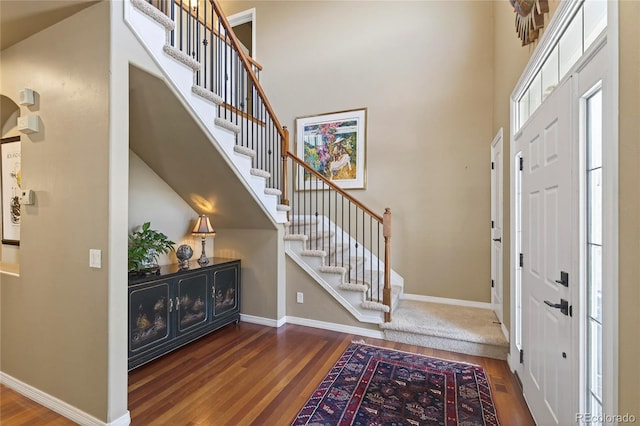 4545 S Monaco St Unit 114, Denver, CO 80237 - foyer with wood finished floors, stairs, and a high ceiling