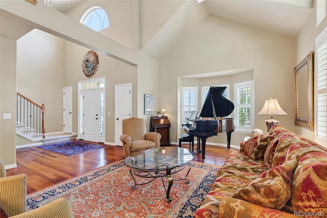 4545 S Monaco St Unit 114, Denver, CO 80237 - living area featuring high vaulted ceiling, wood finished floors, and stairs