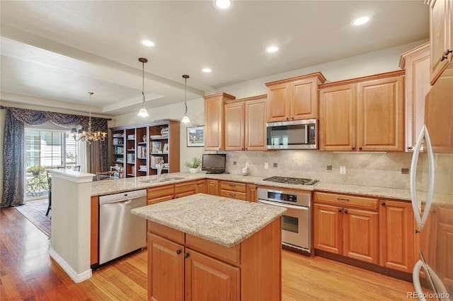 4545 S Monaco St Unit 114, Denver, CO 80237 - kitchen with stainless steel appliances, a peninsula, light wood-style flooring, tasteful backsplash, and light stone countertops