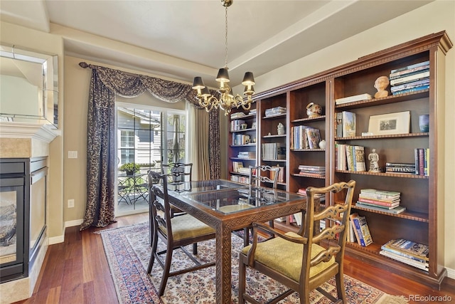 4545 S Monaco St Unit 114, Denver, CO 80237 - dining space with a chandelier, dark wood finished floors, a multi sided fireplace, and a raised ceiling