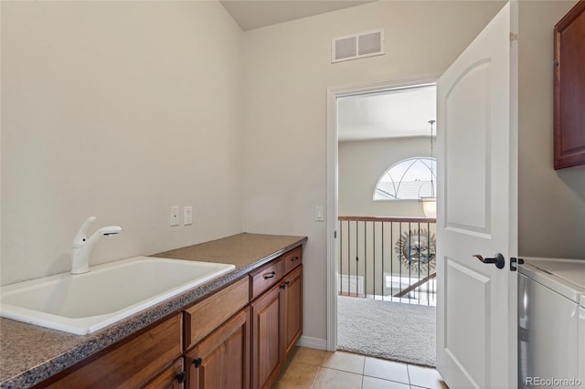 4545 S Monaco St Unit 114, Denver, CO 80237 - bathroom featuring tile patterned floors and washer / clothes dryer