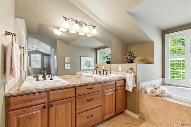 4545 S Monaco St Unit 114, Denver, CO 80237 - full bath with vaulted ceiling, healthy amount of natural light, double vanity, a bath, and tile patterned flooring
