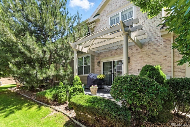 4545 S Monaco St Unit 114, Denver, CO 80237 - back of property featuring brick siding and a pergola