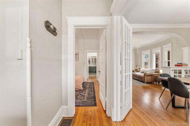 222 S Logan St, Denver, CO 80209 - hallway with light wood finished floors and crown molding