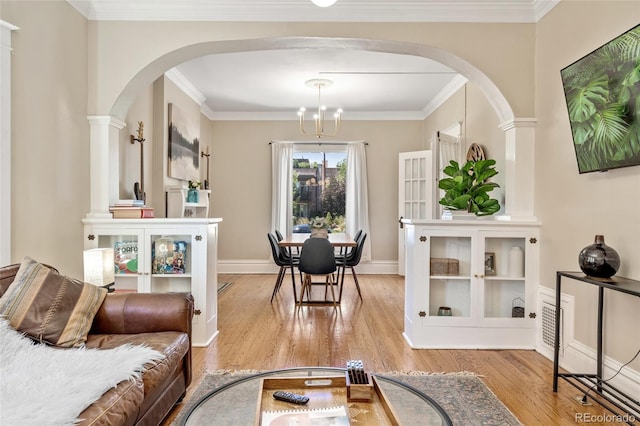 222 S Logan St, Denver, CO 80209 - living room with arched walkways, wood finished floors, a chandelier, and crown molding