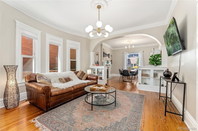 222 S Logan St, Denver, CO 80209 - living area with a chandelier, arched walkways, wood finished floors, and crown molding