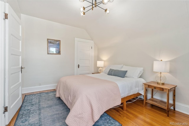 222 S Logan St, Denver, CO 80209 - bedroom featuring wood finished floors, lofted ceiling, and a chandelier