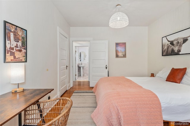 222 S Logan St, Denver, CO 80209 - bedroom with wood finished floors and a sink