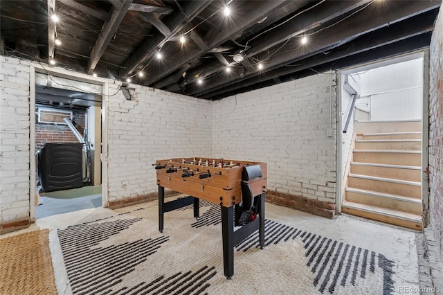 222 S Logan St, Denver, CO 80209 - playroom with a wood stove, brick wall, and concrete floors