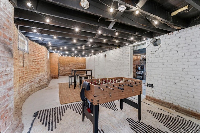 222 S Logan St, Denver, CO 80209 - playroom with brick wall and unfinished concrete floors