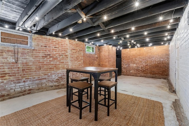 222 S Logan St, Denver, CO 80209 - dining area featuring concrete flooring and brick wall
