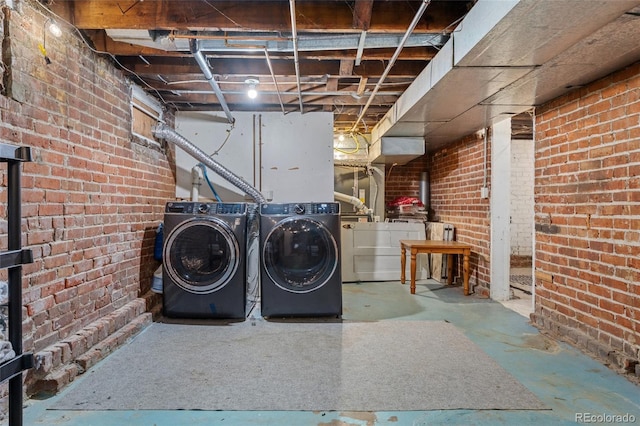 222 S Logan St, Denver, CO 80209 - laundry room featuring separate washer and dryer and brick wall