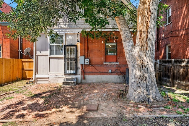 222 S Logan St, Denver, CO 80209 - view of front facade featuring a fenced backyard, entry steps, and brick siding