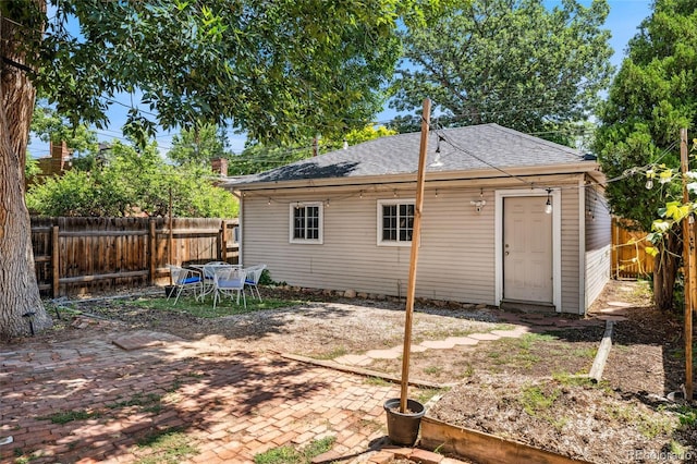 222 S Logan St, Denver, CO 80209 - rear view of property with a fenced backyard, roof with shingles, and a patio area