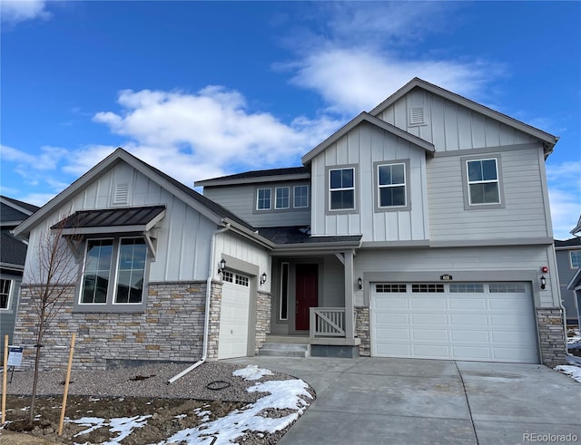 view of front of property with stone siding, board and batten siding, and concrete driveway