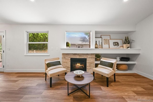 5554 S Ward Way, Littleton, CO 80127 - sitting room with baseboards, a stone fireplace, and wood finished floors