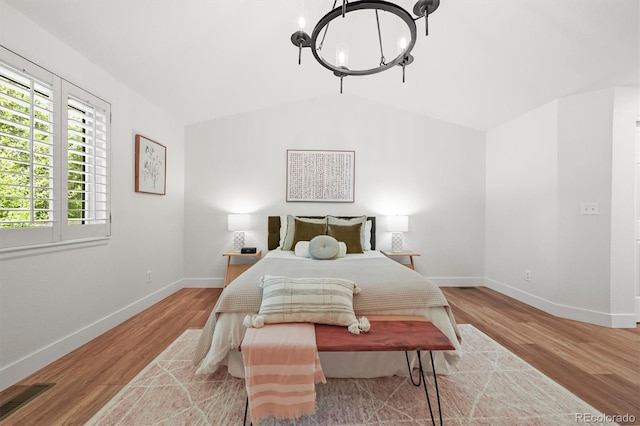 5554 S Ward Way, Littleton, CO 80127 - bedroom featuring a chandelier, baseboards, wood finished floors, and vaulted ceiling