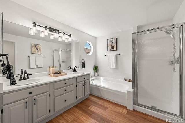 5554 S Ward Way, Littleton, CO 80127 - full bath with a shower stall, a garden tub, double vanity, and wood finished floors