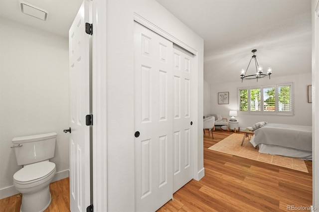 5554 S Ward Way, Littleton, CO 80127 - bedroom featuring light wood-style floors, a chandelier, a closet, and baseboards