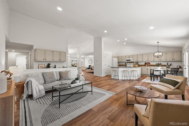 5554 S Ward Way, Littleton, CO 80127 - living area featuring light wood-style flooring, high vaulted ceiling, recessed lighting, and a chandelier