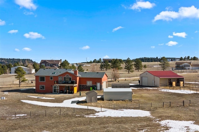 view of yard with a garage, a pole building, an outdoor structure, and fence