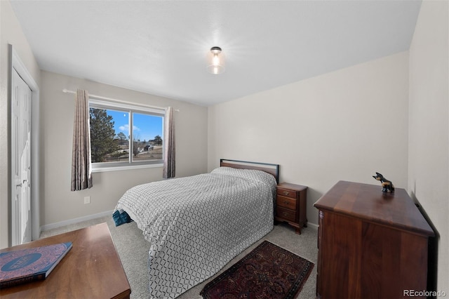 carpeted bedroom featuring baseboards