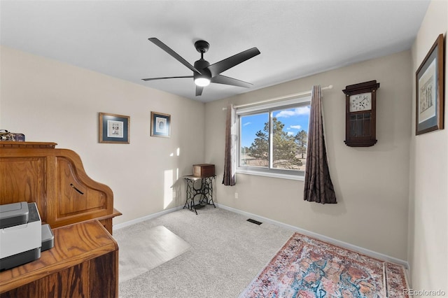 office with visible vents, ceiling fan, baseboards, and carpet