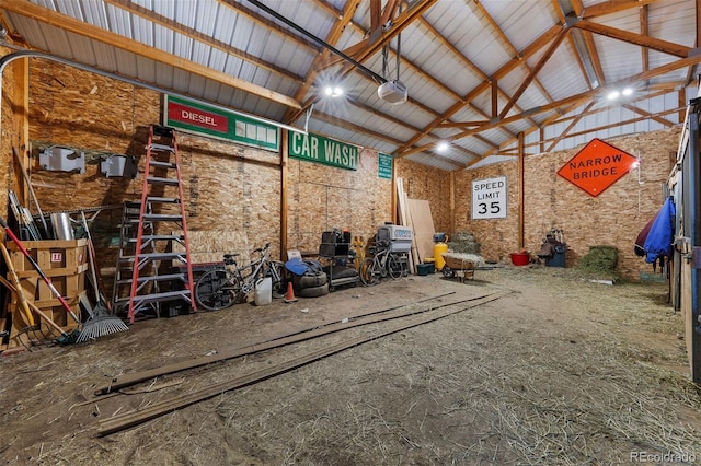 garage featuring a garage door opener and metal wall