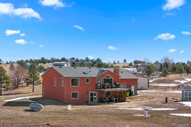 rear view of house featuring a patio and fence