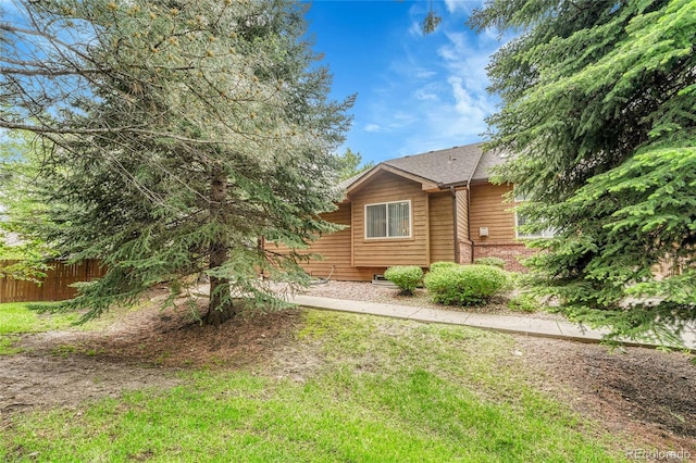 11820 W 66th Pl Unit C, Arvada, CO 80004 - view of home's exterior with roof with shingles and brick siding