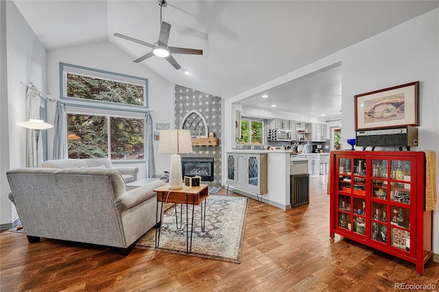11820 W 66th Pl Unit C, Arvada, CO 80004 - living area with a fireplace, a ceiling fan, high vaulted ceiling, and wood finished floors