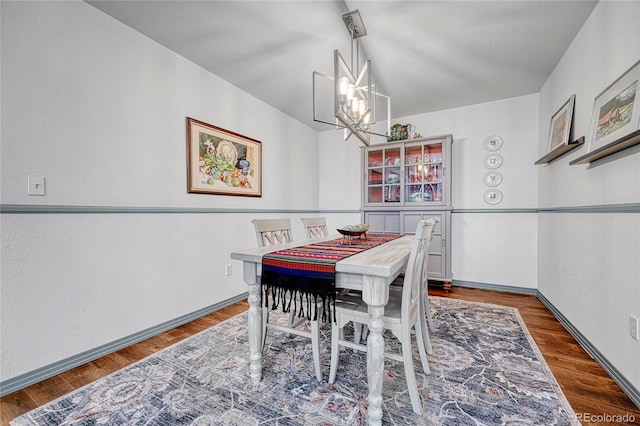 11820 W 66th Pl Unit C, Arvada, CO 80004 - dining space with a chandelier, baseboards, and wood finished floors